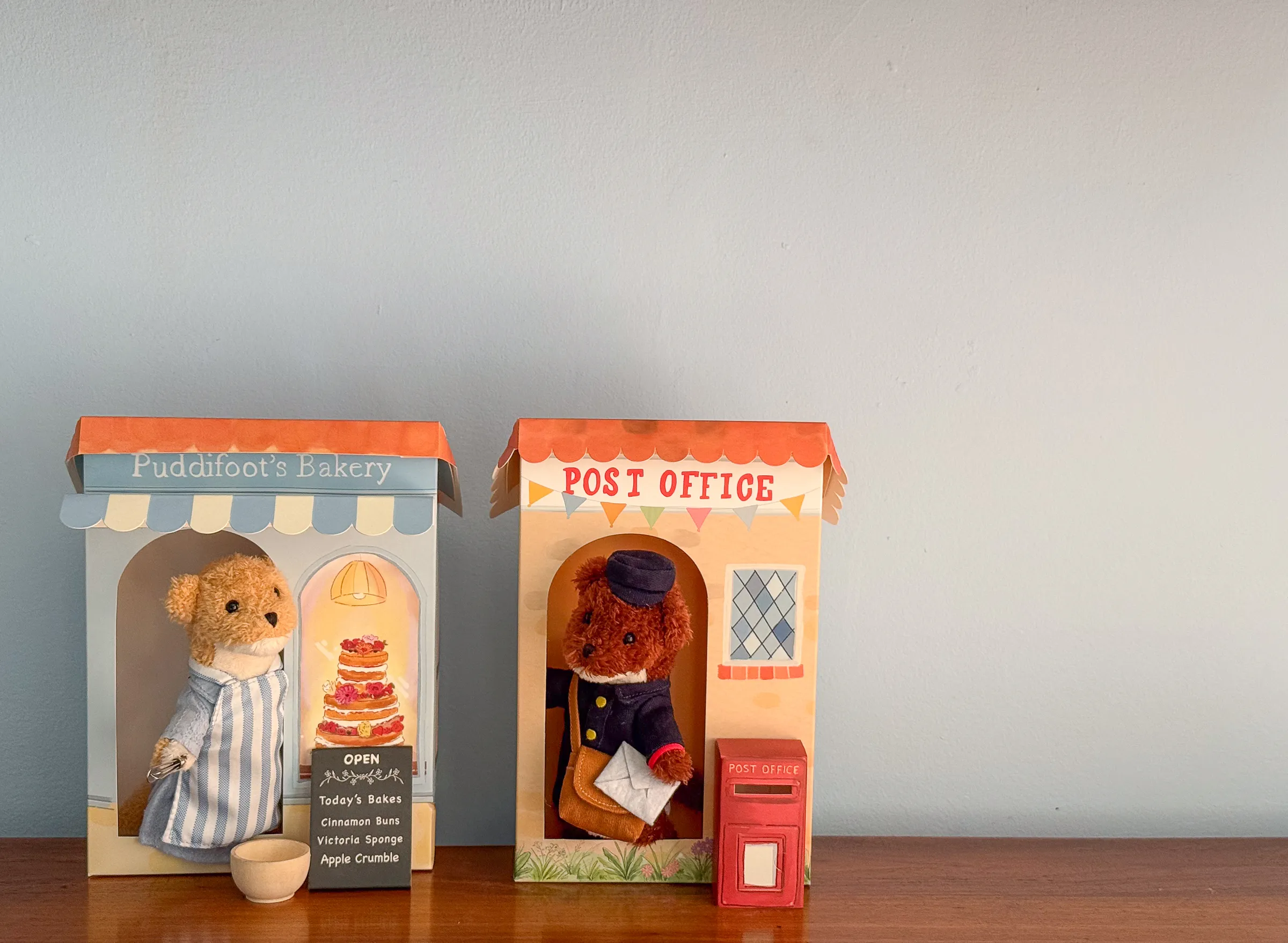 Eleanor Puddifoot in her hand-illustrated bakery beside Albert the Postman at the Post Office