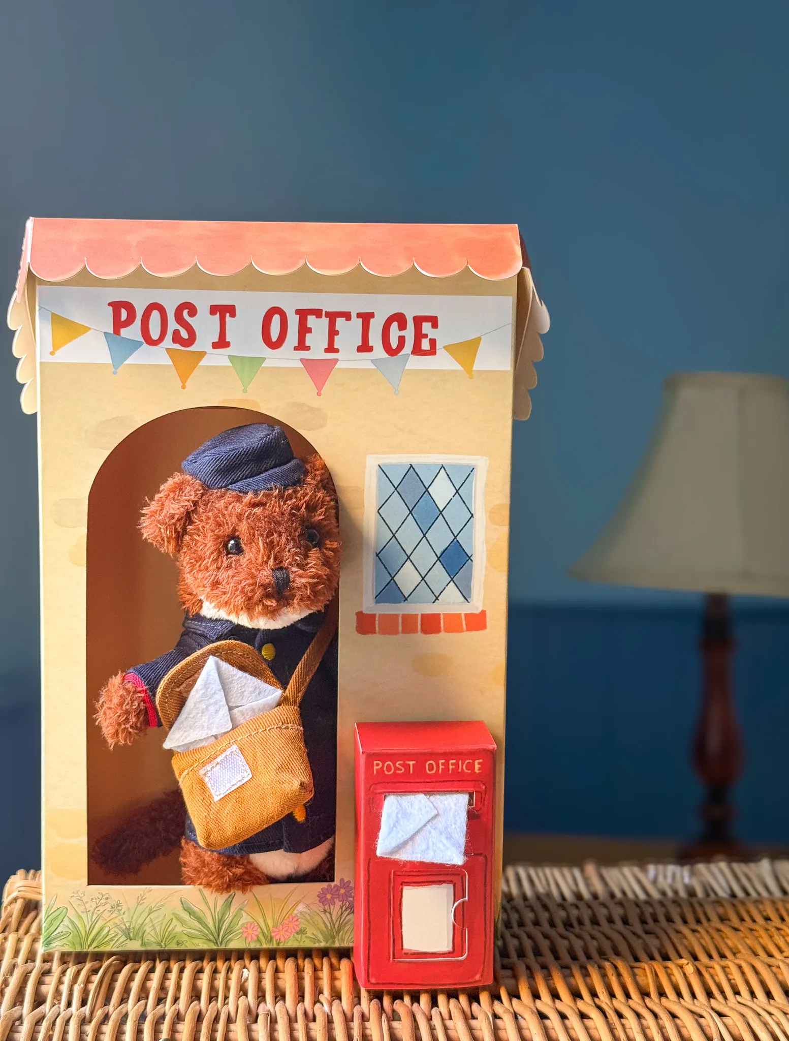 Albert the Postman tucked onto a nursery shelf