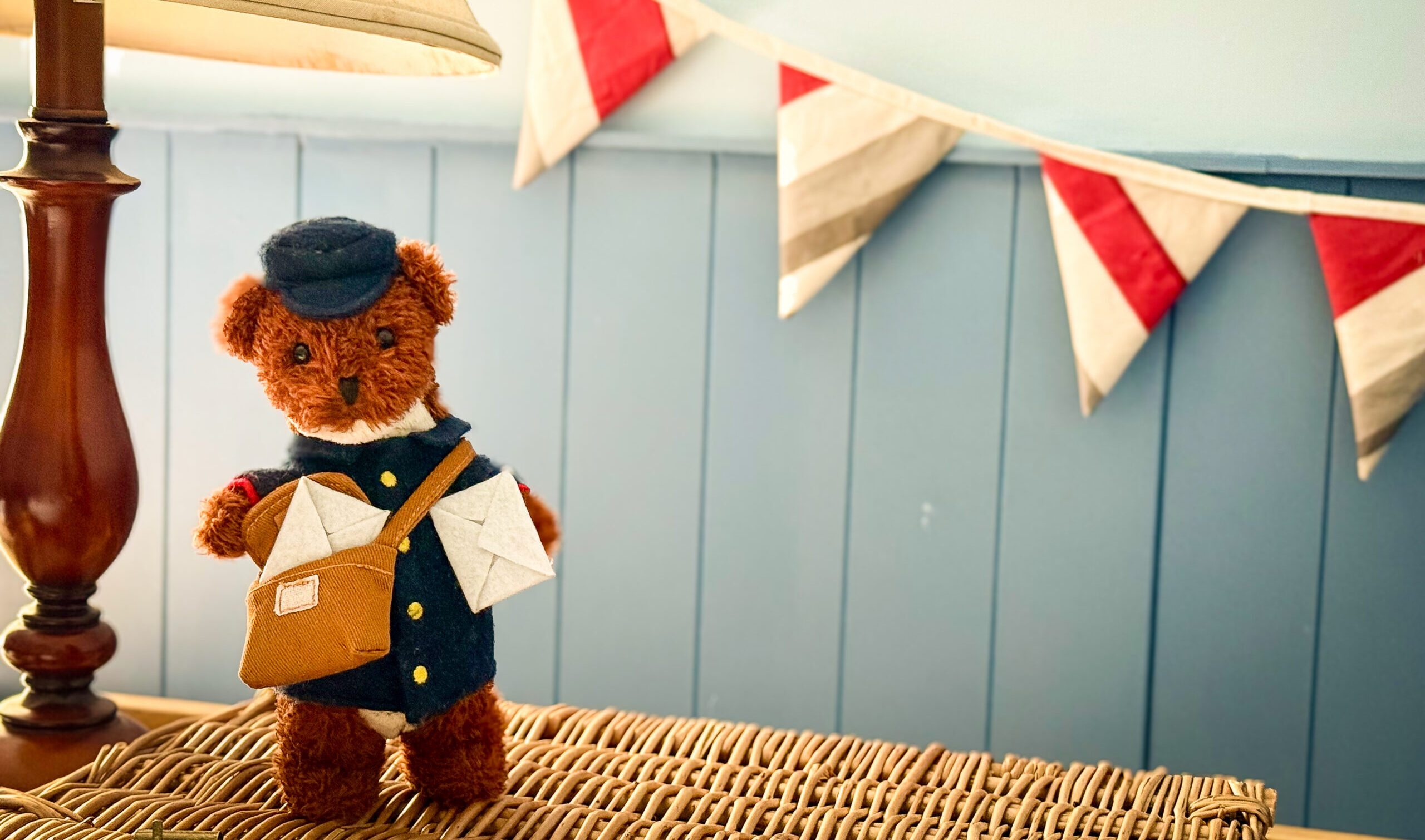 A daylight photograph of Albert the Postman,plush stoat toy by Mimkin